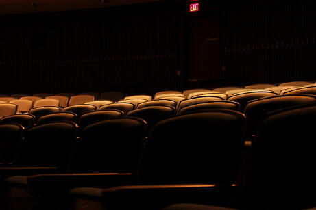 A photograph of dimly lit seats in an empty theater. September 2024.